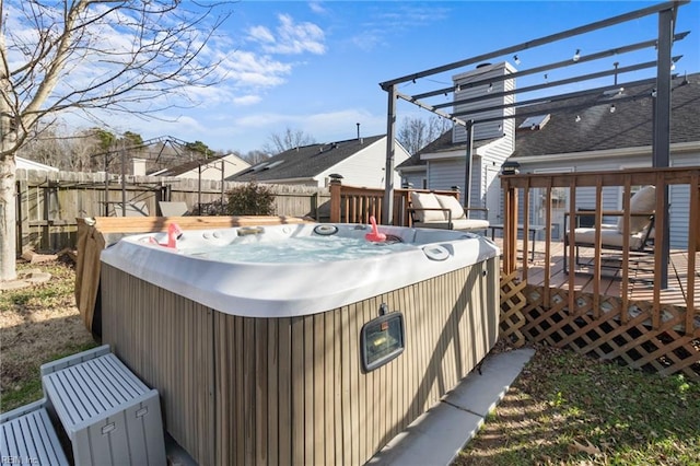 view of patio featuring a hot tub and a deck