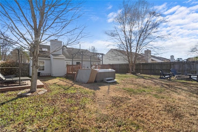 view of yard with a hot tub and a wooden deck