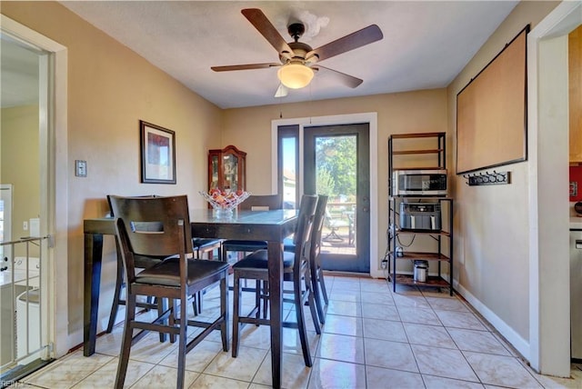 tiled dining area featuring ceiling fan