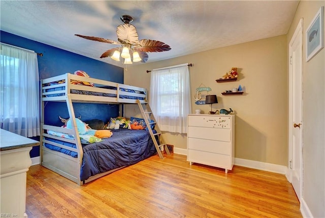 bedroom featuring ceiling fan and light hardwood / wood-style flooring