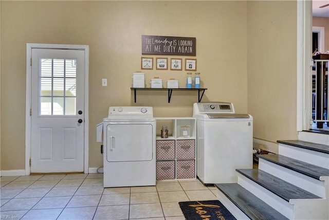 laundry room featuring washer and dryer and light tile patterned floors