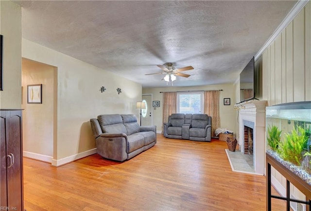 living room featuring ceiling fan and light wood-type flooring