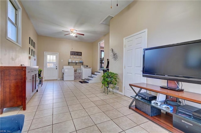 tiled living room featuring ceiling fan and washer and clothes dryer