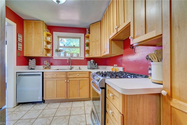 kitchen featuring light brown cabinetry, stainless steel appliances, and sink