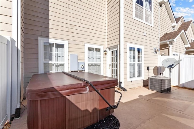 view of patio with cooling unit and a hot tub