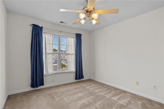 carpeted empty room featuring ceiling fan