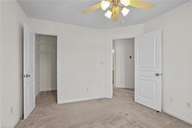 unfurnished bedroom featuring ceiling fan, light carpet, and a closet