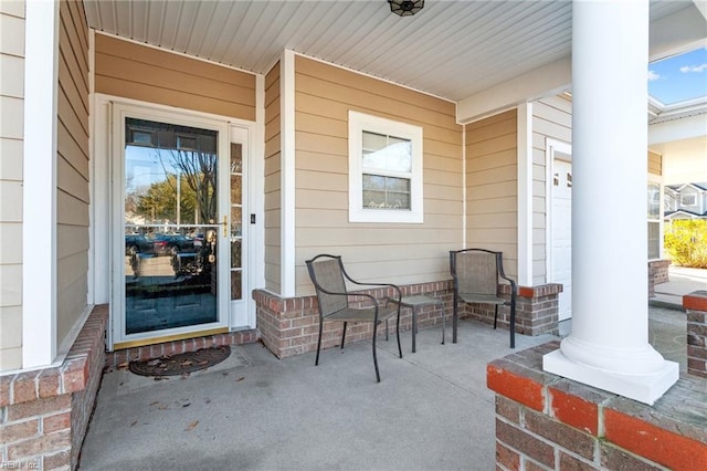 view of exterior entry featuring a porch