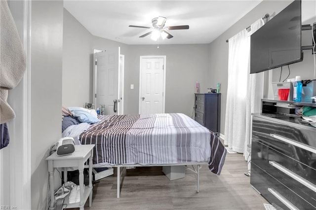 bedroom featuring ceiling fan and light hardwood / wood-style floors