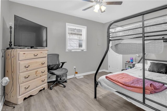 bedroom with wood-type flooring and ceiling fan