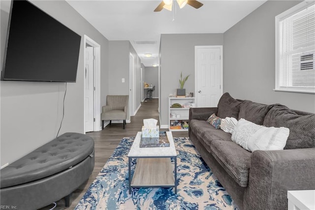 living room featuring dark hardwood / wood-style floors and ceiling fan