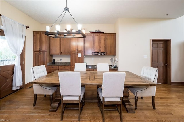 dining room featuring dark hardwood / wood-style flooring and a notable chandelier