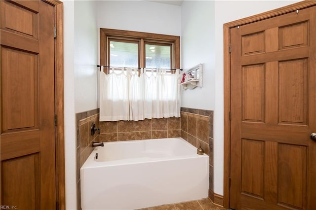 bathroom with tile patterned floors and a washtub