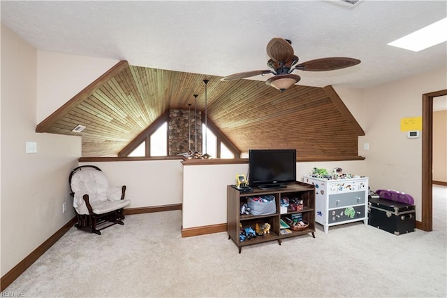 living area featuring carpet flooring, ceiling fan, wooden ceiling, and lofted ceiling