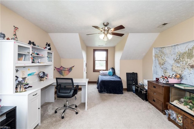 carpeted office with ceiling fan, lofted ceiling, and a textured ceiling