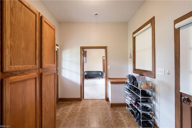 hall with a textured ceiling