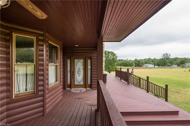 wooden deck with a lawn and a porch