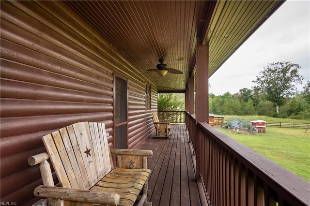 deck with a lawn and ceiling fan