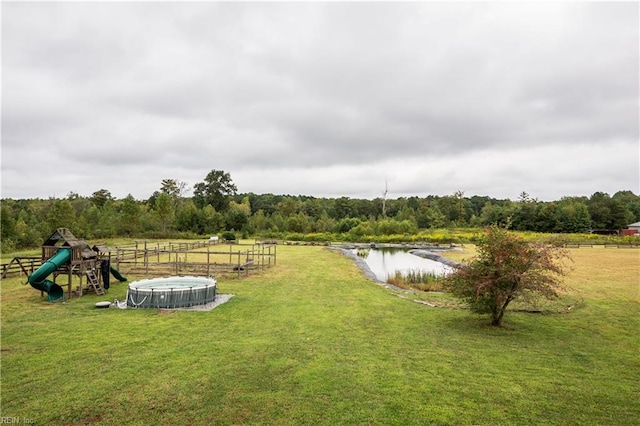 view of yard featuring a playground and a water view