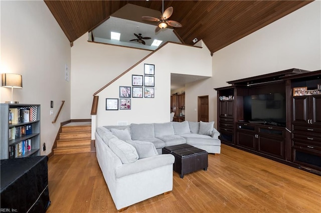 living room with hardwood / wood-style floors, ceiling fan, wood ceiling, and high vaulted ceiling