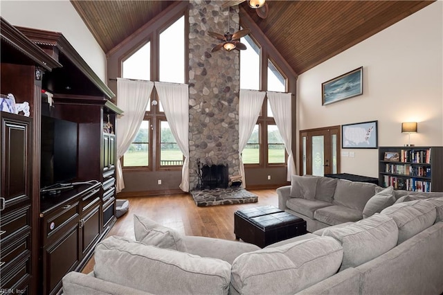 living room featuring a fireplace, light hardwood / wood-style flooring, high vaulted ceiling, and wood ceiling