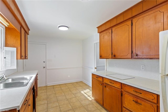 kitchen featuring sink and white fridge