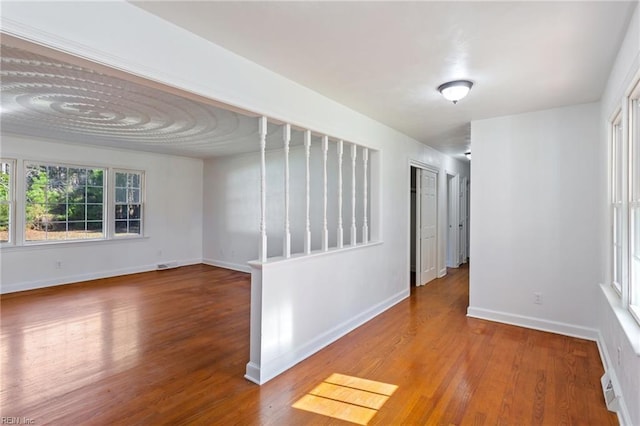 empty room with hardwood / wood-style floors