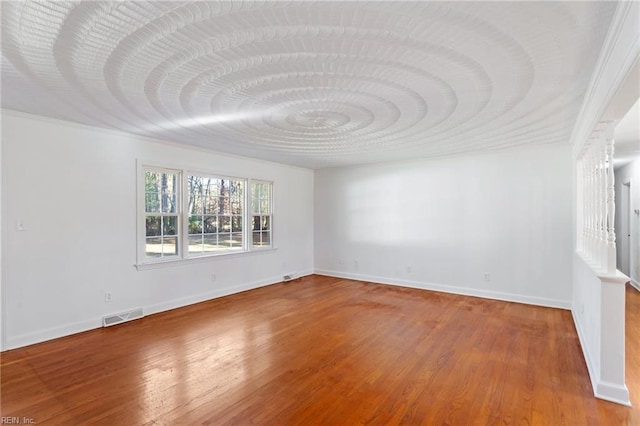 unfurnished room featuring hardwood / wood-style flooring and ornamental molding