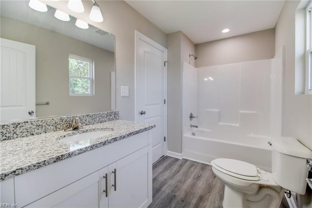 full bathroom with vanity, shower / bathing tub combination, wood-type flooring, and toilet