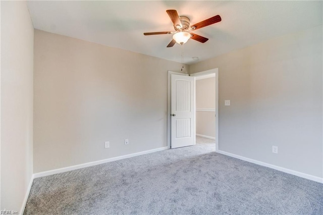 empty room with ceiling fan and carpet floors