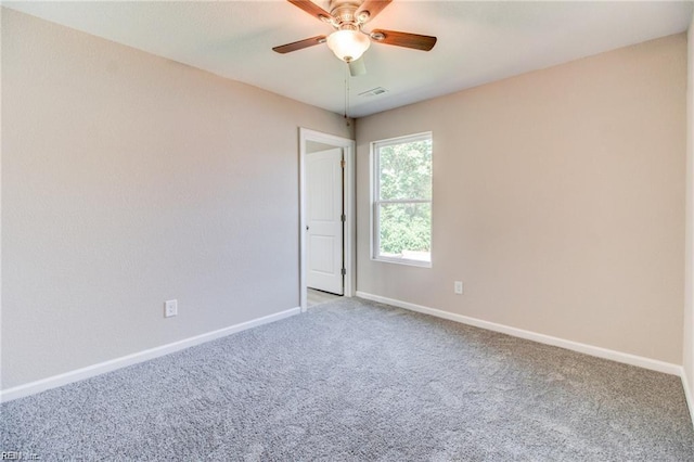 carpeted empty room featuring ceiling fan