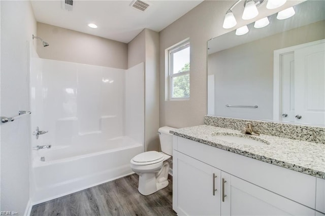 full bathroom with hardwood / wood-style floors, vanity, toilet, and bathing tub / shower combination