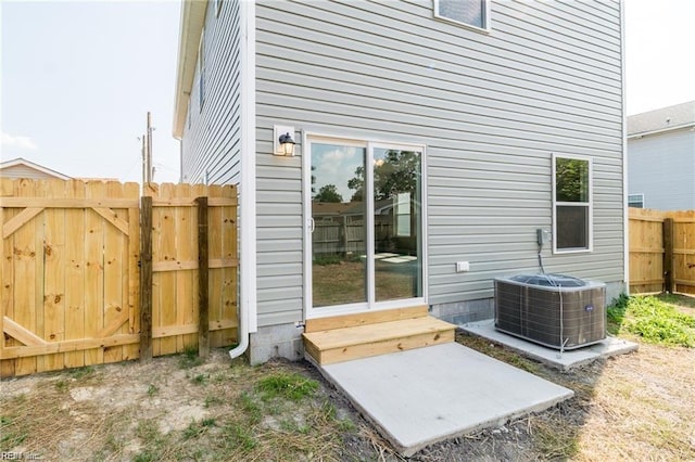 rear view of property with cooling unit