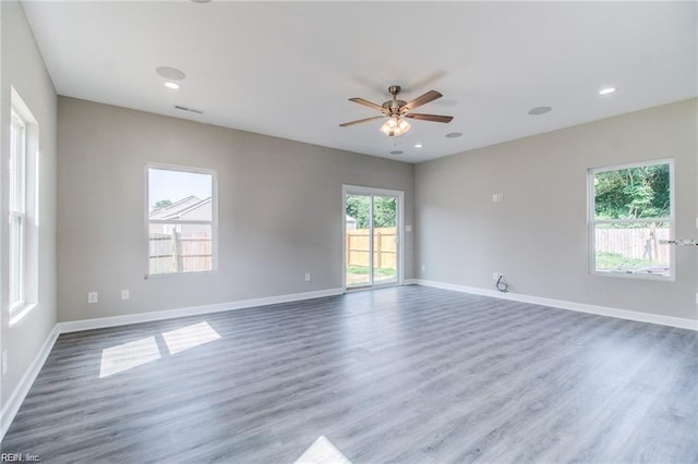 unfurnished room featuring dark hardwood / wood-style floors and ceiling fan