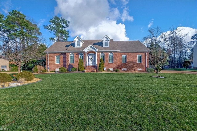 new england style home featuring a front lawn