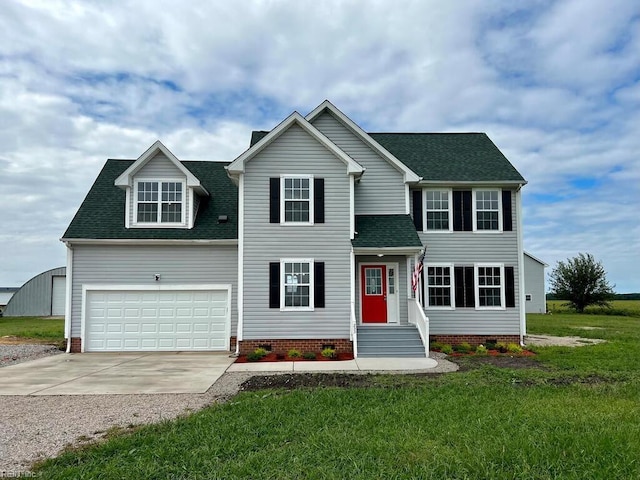 view of front of property featuring a front yard and a garage