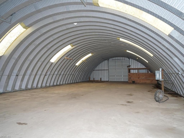 miscellaneous room with concrete flooring and lofted ceiling