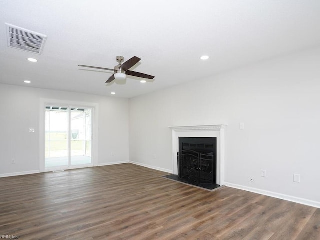 unfurnished living room featuring dark hardwood / wood-style flooring and ceiling fan