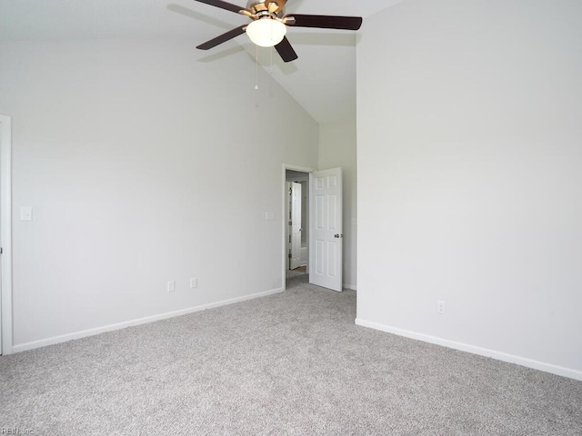 carpeted spare room with ceiling fan and high vaulted ceiling