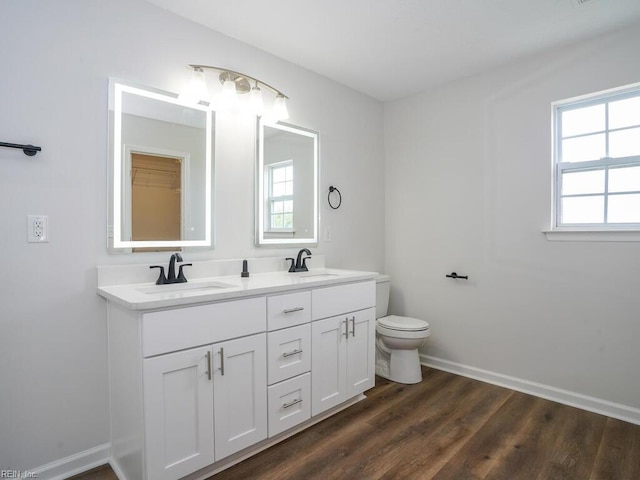 bathroom featuring vanity, toilet, and wood-type flooring