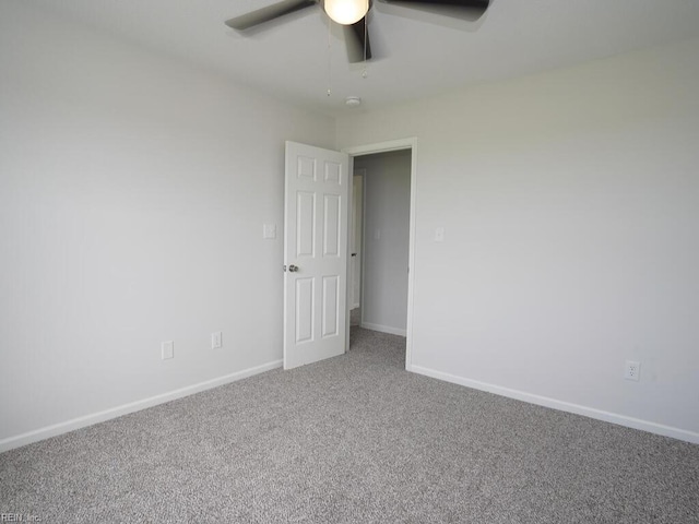 spare room featuring ceiling fan and carpet floors