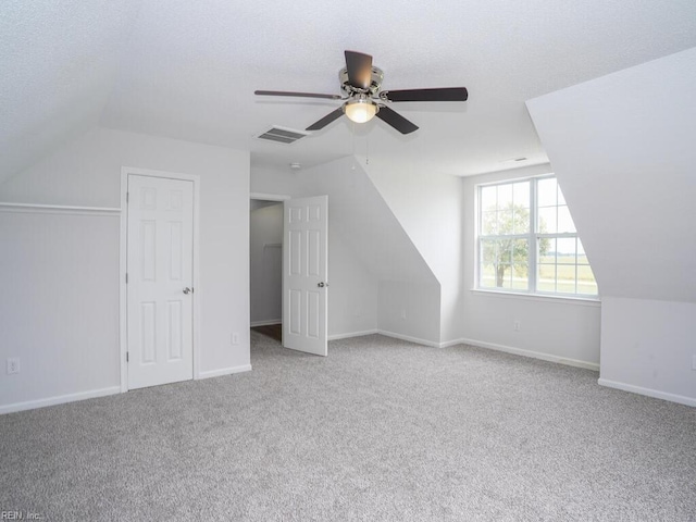 bonus room featuring light colored carpet, ceiling fan, and lofted ceiling