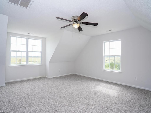 additional living space featuring carpet flooring, ceiling fan, and vaulted ceiling