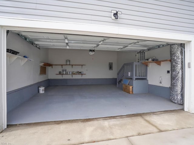 garage featuring a garage door opener and electric panel