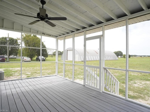 unfurnished sunroom with ceiling fan and lofted ceiling