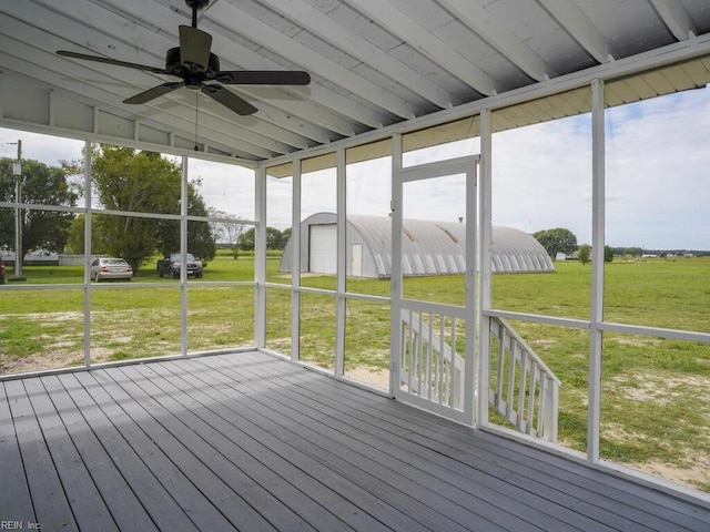 unfurnished sunroom featuring ceiling fan and vaulted ceiling