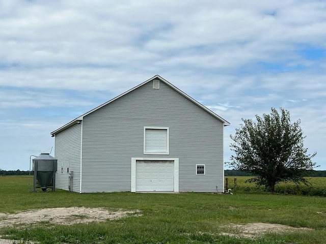 view of side of home with a yard and a garage