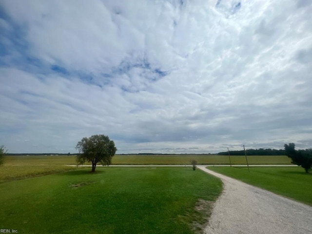 view of home's community with a yard and a rural view