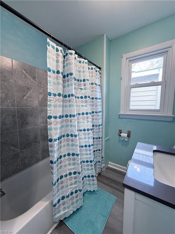 bathroom featuring shower / bathtub combination with curtain, vanity, and wood-type flooring