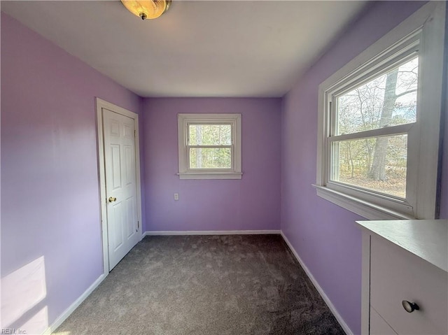 spare room featuring a wealth of natural light and light colored carpet